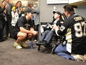 Pittsburgh Penguins centre Sidney Crosby spends time with eight-year-old Matthew Jacko at the Consol Energy Centre in Pittsburgh, Oct. 31, 2013. (PittsburghPenguins.com)