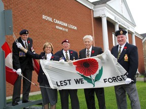 The Lest We Forget flag was raised at the Royal Canadian Legion Branch 62 in Sarnia Friday to mark the beginning of Remembrance Days from Nov. 1 to Nov. 11.  Pictured are poppy chairman Ron Chafe, left,  Lynn Mathieson, Simon Vanderbyl, Sarnia City Councillor Jim Foubister, and Bill Douglas. (MELANIE ANDERSON, The Observer)