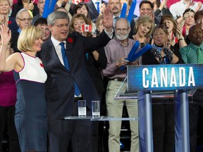 Canadian Prime Minister Stephen Harper and his wife Laureen wave to the crowd after delivering the keynote address Friday during the Conservative Convention in Calgary. Behind them, directly to the right, are Sarnia's Marilyn Gladu and Dick Carpani REUTERS/Todd Korol