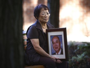 Virginia Kan holds a portrait of her late husband Tyron. Kan was in the vehicle when her husband died in a crash. (Craig Robertson/Toronto Sun)
