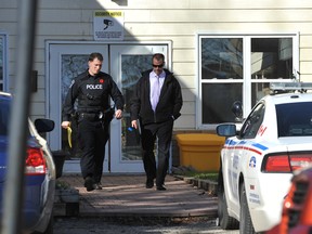 Members of the Barrie police leave a North Street building where a homicide took place in November of 2013.
EXAMINER FILE