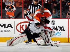Ray Emery #29 of the Philadelphia Flyers fights with Braden Holtby #70 of the Washington Capitals during the third period at the Wells Fargo Center on November 1, 2013 in Philadelphia, Pennsylvania. The Capitals shutout the Flyers 7-0.  (Bruce Bennett/Getty Images/AFP)