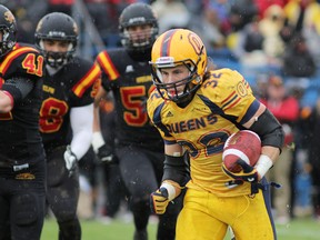 Queen’s Golden Gaels’ Ryan Granberg runs for gain during the first half of Saturday’s playoff game against Guelph. (Elliot Ferguson The Whig-Standard)