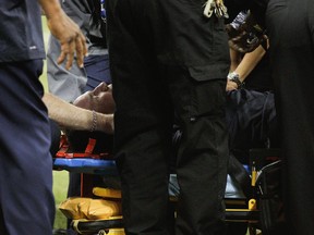 Texans head coach Gary Kubiak is loaded on a stretcher after he collapsed on the field as the team left for halftime against the Indianapolis Colts at Reliant Stadium on November 3, 2013 in Houston, Texas.   (Bob Levey/Getty Images/AFP)