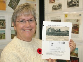 Brenda Hoyles poses with a page from her display on Kent County agriculture at Kentpex 2013 held on Nov. 2 at the Active Lifestyles Centre in Chatham.