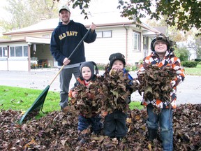 Warmer temperatures and sunshine at the end of October was the perfect time to do some fall raking. Above, Curtis Vessie smiles as his sons Taitum (left), Reegan (centre) and Nolan, helped gather leaves while he raked the front yard last Tuesday, Oct. 29. The sun was welcomed after the wet snow the region received the week before, but now with the time change, expect more snow-like temperatures and cold. KRISTINE JEAN/MITCHELL ADVOCATE