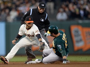 Seth Smith #15 of the Oakland Athletics slides into second base with a double, beating the tag of Brandon Crawford #35 of the San Francisco Giants in the fourth inning at AT&T Park on May 29, 2013 in San Francisco, California.  (Thearon W. Henderson/Getty Images/AFP)