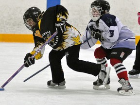 Hannah Redfern of the Mitchell U12 ringette team heads for the net while being chased by this St. Marys defender during WRRL action Sunday, Nov. 3 in Mitchell. Redfern scored two goals, including the tying goal, in an exciting 7-7 tie. ANDY BADER/MITCHELL ADVOCATE