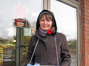 Tracey Phillips was one of a handful of volunteers distributing poppies throughout Mitchell last Saturday, Nov. 2. KRISTINE JEAN/MITCHELL ADVOCATE