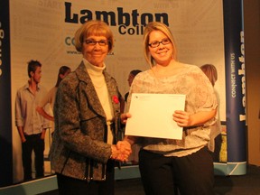 Amanda Griffith receives the Dr. Gordon Henderson Memorial Award at Lambton College's Academic Awards Ceremony on Tuesday from Wendy Heasman. Griffith, a mother of four, walked away with three Lambton College academic awards.  A total of 146 awards totalling more than $175,000 were handed out to recent graduates and current students. (MELANIE ANDERSON, The Observer)