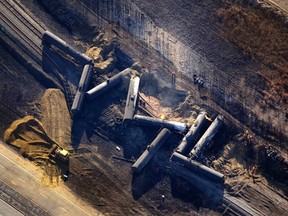 Investigators survey the site of a train derailment near the hamlet of Gainford, west of Edmonton October 20, 2013. The Canadian National Railway train carrying petroleum crude oil and liquefied petroleum gas derailed west of Edmonton, Alberta, the Transportation Safety Board of Canada said on October 19. (REUTERS/Dan Riedlhuber)