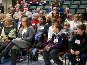Community members listen at a special Algonquin and Lakeshore Catholic District School Board meeting to close some Kingston elementary schools on Tuesday evening at Regiopolis Notre-Dame Secondary School. (Ian MacAlpine The Whig-Standard)