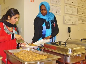 Mehreen Emad, left, and Halima Dent serve some traditional cuisine at the Sarnia Muslim Association's ethnic dinner on Nov. 4. The event attracted about 400 diners and raised about $8,000 in aid of Syrian refugees through Islamic Relief Canada.
HEATHER YOUNG/ SARNIA THIS WEEK/ QMI AGENCY