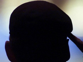 An unknown soldier gives a salute during the Memorial Service at Skyreach Centre in Edmonton in this April 28, 2002 file photo. (QMI Agency files)