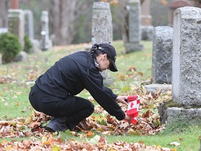 Leading seaman Alicia Abbott, from HMCS Cataraqui, places a Canadian flag in front of a military headstone in Cataraqui Cemetery to honour their service.
Michael Lea The Whig-Standard