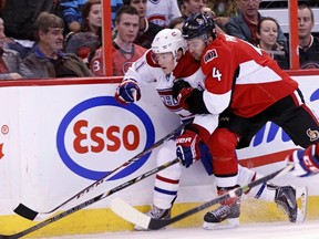 Ottawa Senators' Chris Phillips battles with Montreal Canadiens' Brendan Gallagher during preseason NHL hockey action at the Canadian Tire Centre in Ottawa in September.