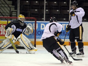 Sarnia Sting Brodie Barrick prepares to take a backhand shot from Vladislav Kodola at practice on Wednesday. The Sting kick off a three game road swing on Thursday with a trip to St. Catharines to play the Niagara IceDogs, a homecoming of sorts for Barrick, who is from the neighbouring town of Welland. SHAUN BISSON/THE OBSERVER/QMI AGENCY