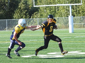 Lively Hawks quarterback Hunter Holub scrambles away from a Notre Dame Alouettes defender during high school football action at James Jerome Sports Complex in this September 2012 file photo. Holub is this week's Sudbury Star/Cambrian College GameChanger. GINO DONATO/THE SUDBURY STAR/QMI AGENCY