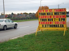 A car travels Fairview Ave. in St. Thomas, passing a sign advertising a public meeting about a proposal to widen the roadway. Council is considering an option to widen Fairview Ave. to four lanes from the current two between Elm St. and Southdale Line.