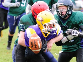 East Elgin's Tim Nanephosy coughs up the ball Thursday, one of several fumbles the Eagles gave up as they lost 20-11 to the Laurier Rams in TVRA junior football playoff action in Aylmer.  (R. MARK BUTTERWICK, Times-Journal)