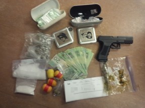 A Kingston man faces 11 charges after a traffic stop and subsequent investigation netted drugs and weapons.