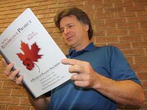 Retired St. Pat's teacher Tom Slater looks through "The War Remembrance Project."  Slater spent months complying information on Sarnia-Lambton's fallen soldiers from the Boer, First and Second World, and the Korean wars, as well as the peacekeeping mission in Afghanistan. (BARBARA SIMPSON, The Observer)