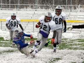 Even though this game was on the turf at Fuhr Sports Park, the snow cover made the footing treacherous for the defences, as shown here when a Grove Cougar player misses a tackle as his feet slip out from under him. - Gord Montgomery, Reporter/Examiner