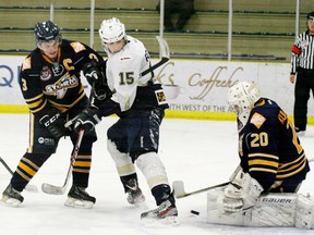 The Saints Tyler Robertson (15), shown here in a battle for the puck in front of the Grande Prairie Storm net, is one of the club’s young players who has taken advantage of the opportunity to get extra ice time with three key players out of the lineup. His improvement has drawn notice from his own coaches as well as other teams. - Gord Montgomery, Reporter/Examiner