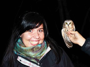 U of A master’s student Justine Kummer, who is studying birds and window collisions, is seen with a flying friend. - Photo Supplied