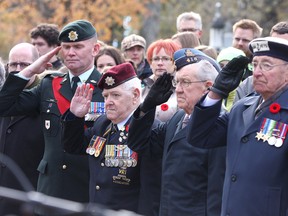 War veterans including Master Warrant Officer R.B. MacRae, Ray Campbell, Cy Yarnell and  Donald Haylock salute during the Cataraqui Cemetery Day of Remembrance Service near the graves of fallen soldiers in Kingston on Friday.
IAN MACALPINE/KINGSTON WHIG-STANDARD/QMI AGENCY