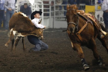 Cody Cassidy competes in the steer wrestling event during Canadian Finals Rodeo at Rexall Place in Edmonton, Alta., on Friday, Nov. 8, 2013.  The CFR continues through Nov. 10. Ian Kucerak/Edmonton Sun/QMI Agency