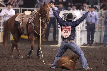Kyle Lucas celebrates a good run in tie-down roping during Canadian Finals Rodeo at Rexall Place in Edmonton, Alta., on Friday, Nov. 8, 2013.  The CFR continues through Nov. 10. Ian Kucerak/Edmonton Sun/QMI Agency