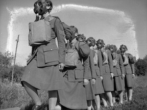 Personnel entering a gas chamber during a training exercise, No.2 Canadian Women’s Army Corps Training Centre, Vermilion, Alberta. July 1943.