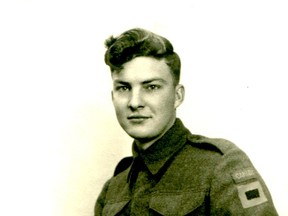 Ellwood Hill in uniform, holding his bible before heading overseas in 1943.