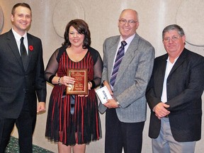 Sandra Cooke Locken, owner of Sarini Fine Jewellery, was presented with the Business of the Year award Oct. 25 during the second annual Ears to You Small Business Awards, which was held at the Vulcan Legion. To her left is Jonathan Allan, economic development officer with the Vulcan Business Development Society, and to her right are Mayor Tom Grant and Dwayne Hill, president of the Vulcan and District Chamber of Commerce.