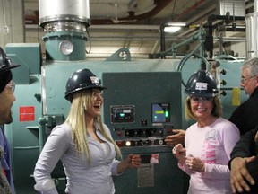 Judith Morris, right, president and CEO of Lambton College, reacts to building noise as a closed-system power plant in the college's new Power Engineering Lab starts up for the first time Saturday. The lab helps make Lambton College one of the leaders in power engineering training in the province, college officials said, and generates enough power to heat the lab. Also pictured is Meagan Wilson, a third-year Power Engineering Technology – Chemical (PET-C) program student. TYLER KULA/ THE OBSERVER/ QMI AGENCY