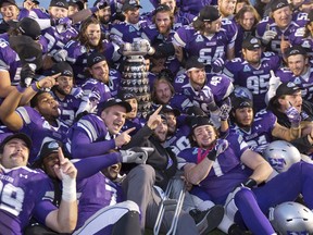 The Western Mustangs pose with the Yates Cup after winning the 106th OUA Yates Cup at TD Stadium in London, Ont. on Saturday November 9, 2013.  The Western Mustangs defeated the Gaels 51-22.
CRAIG GLOVER/The London Free Press/QMI Agency