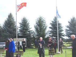 Flags fly at half mast at the Southwold Remebers service Sunday in Shedden.