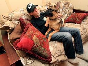 Adrian Lutz sits with his service dog Hope in his basement apartment, 7620 - 75 Ave., in Edmonton, Alberta, on Saturday Nov. 2, 2013. Lutz who suffers from PTSD, served 10 years with the 3rd and 2nd Battalions of the Royal Canadian Regiment.  David Bloom/Edmonton Sun/QMI Agency