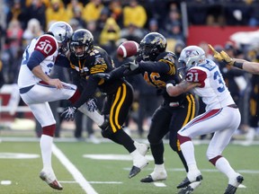 Tiger-Cats block Montreal kicker’s Burke Dales’ punt at the end of the first half on Sunday.