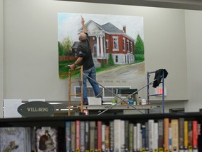 Local artist Ches Sulkowski applies the finishing touches to his wall painting in the redesigned Tillsonburg Public Library, just in time for Thursday's Grand Opening. CHRIS ABBOTT/TILLSONBURG NEWS