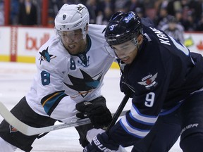 Winnipeg Jets forward Evander Kane (right) battles with San Jose Sharks centre Joe Pavelski during NHL action at MTS Centre in Winnipeg, Man. on Sun., Nov. 10, 2013. Kevin King/Winnipeg Sun/QMI Agency