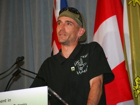 Jason McComb, a community advocate for the homeless, speaks at a ceremony in St. Thomas in June.