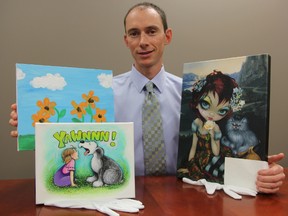 Public education chair Darcy Winch shows off paintings to be auctioned off at the annual Celebrities on Canvas fundraiser Nov. 16. Proceeds will benefit Community Concerns for the Medically Fragile. Pictured here are some of the works up for auction. BARBARA SIMPSON / THE OBSERVER / QMI AGENCY