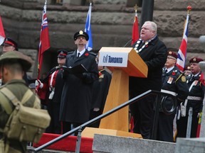 Toronto Mayor Rob Ford reads remarks during Remembrance Day ceremonies at the Old City Hall cenotaph on Monday, November 11, 2013. (Jack Boland/Toronto Sun)