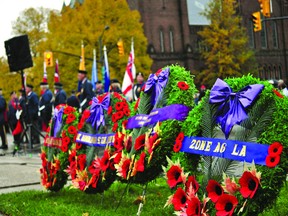 Four wreaths wait to be placed on the Victoria Park cenotaph in London, Ont. during a Remembrance Day ceremony downtown Nov. 11, 2013. CHRIS MONTANINI\LONDONER\QMI AGENCY