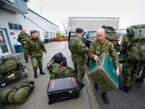 Light engineering and medical technicians from the Canadian Forces posted with 1st Air Canadian Division at CFB Kingston and CFB Petawawa arrive at 8 Wing/CFB Trenton prior to board a C-17 Globemaster aircraft Monday, Nov. 11, 2013 - JEROME LESSARD/The Intelligencer