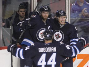 Winnipeg Jets left winger Andrew Ladd (l) and Winnipeg Jets defenceman Zach Bogosian  celebrate a first period goal against the Detroit Red Wings  by Winnipeg Jets center Bryan Littleduring NHL hockey in Winnipeg, Man. Monday, November 04, 2013.
Brian Donogh/Winnipeg Sun/QMI Agency