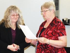 Coun. Lorna Armstrong is sworn into office Oct. 28 while Town lawyer Karen Currie looks on. After council members were sworn in, they were appointed to boards and committees.