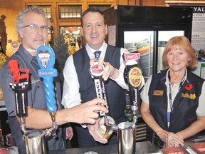 Lake of the Woods Brewery owner Taras Manzies, Kenora MP Greg Rickford and FedNor representative Pamela Bryson pour a pint at the beer garden set up by the local brewery at the Royal Agricultural Winter Fair in Toronto on Friday, Nov. 8.